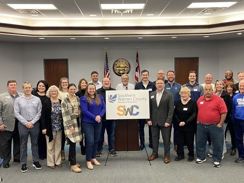 SWC members in front of a sign